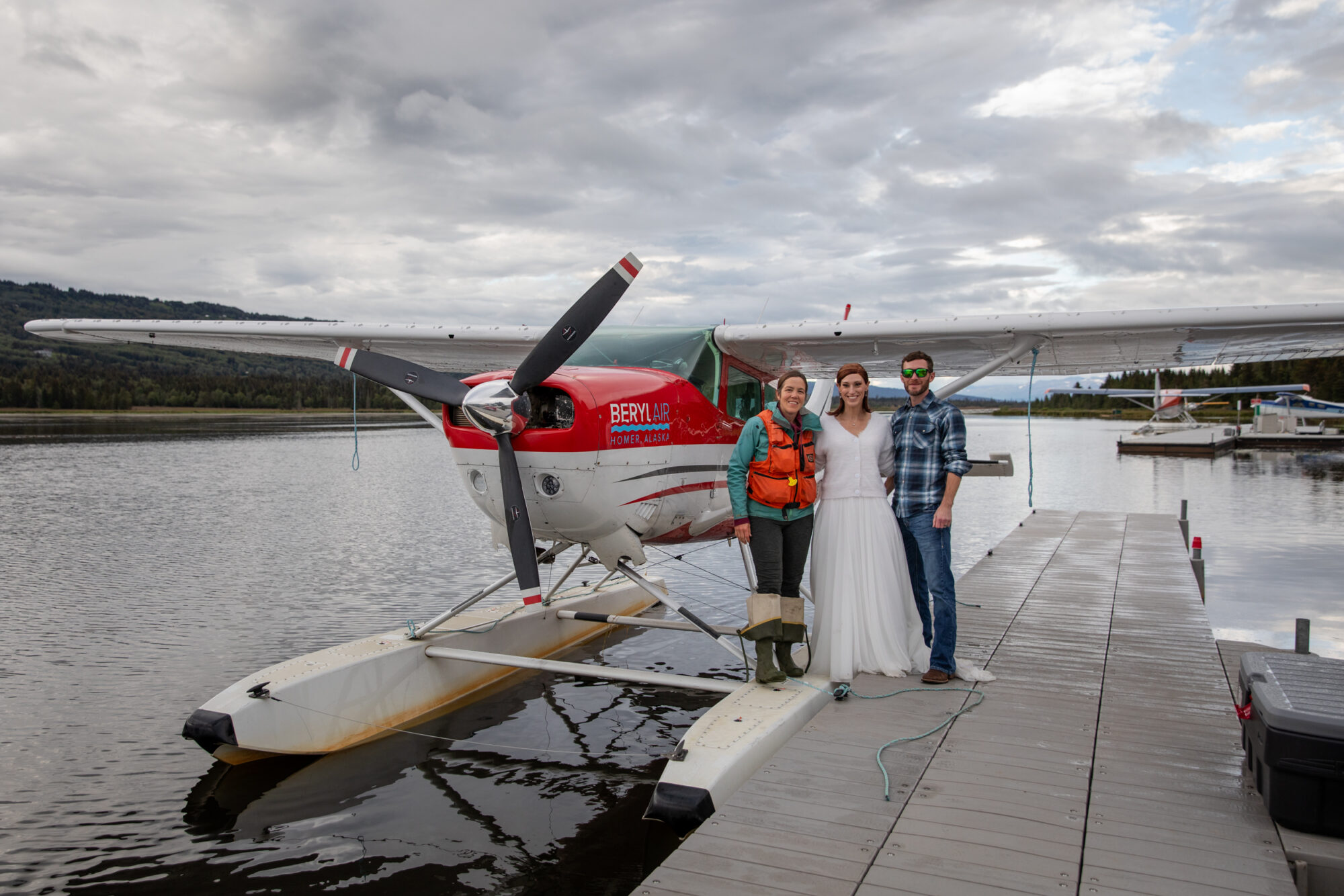 couple and bush pilot after a Homer Alaska elopement accessed by floatplane in a remote lake setting