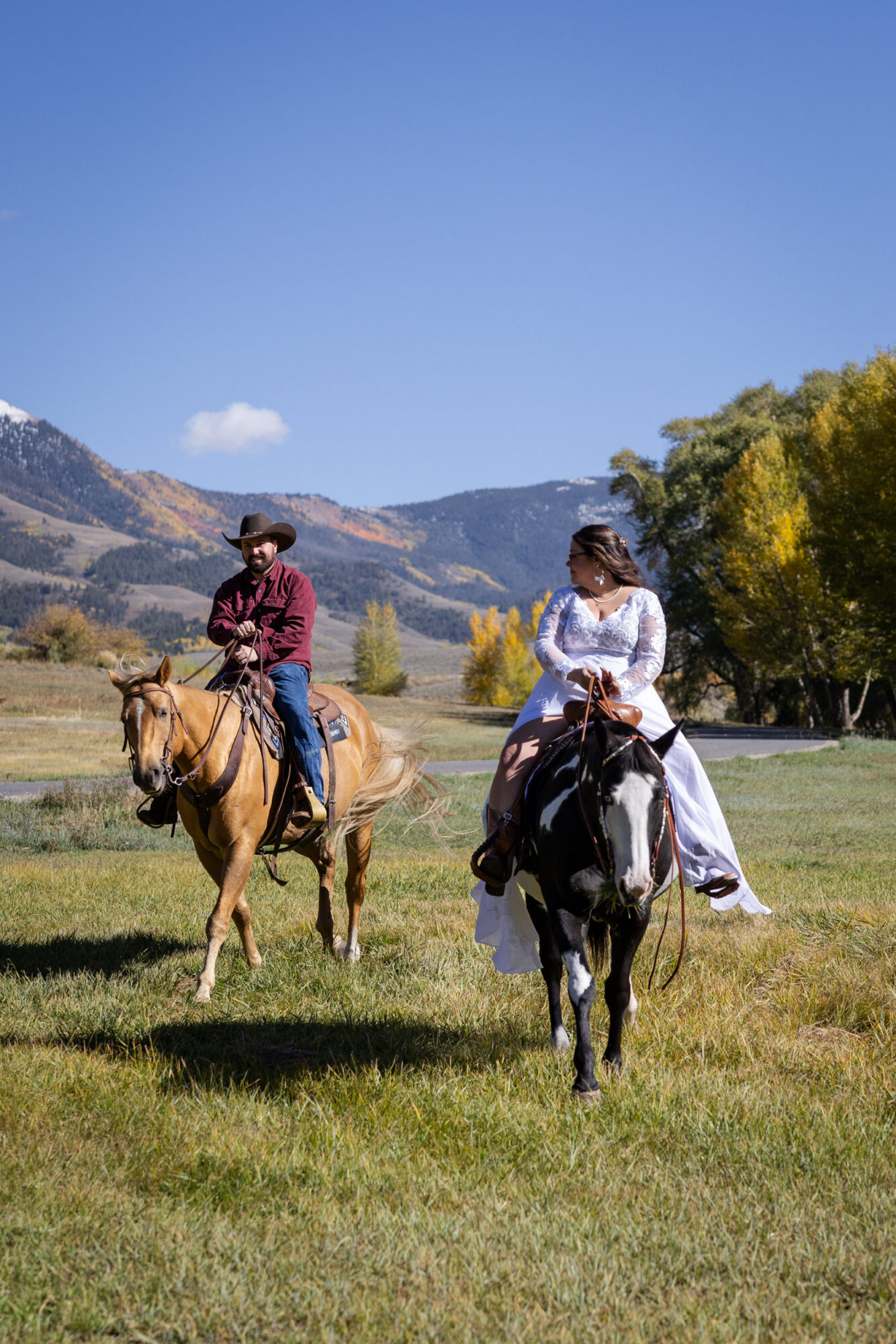 A Loveland Pass Elopement in Colorado: Horseback Riding and a Mountain Wedding | Scenic Vows Bride and groom horseback riding during a Colorado mountain elopement near Loveland Pass