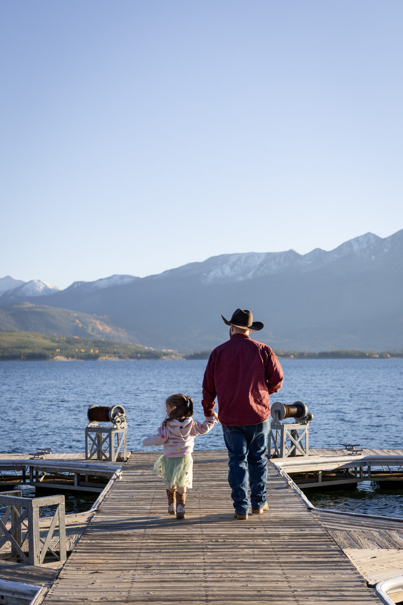 A Loveland Pass Elopement in Colorado: Horseback Riding and a Mountain Wedding | Scenic Vows Family walking on a dock after a small Colorado mountain elopement near Loveland Pass