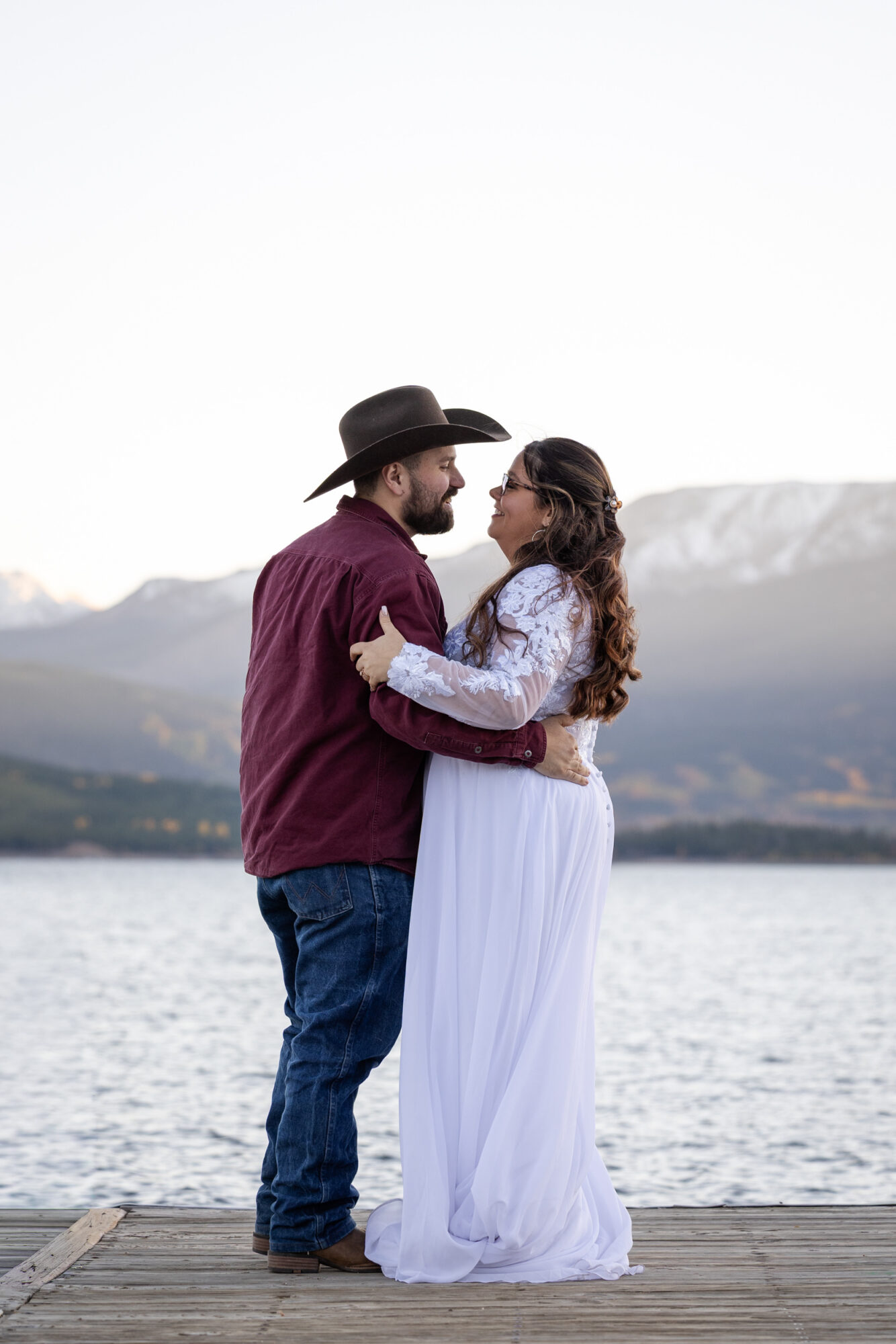 A Loveland Pass Elopement in Colorado: Horseback Riding and a Mountain Wedding | Scenic Vows Couple embracing by a mountain lake during their Loveland Pass elopement in Colorado