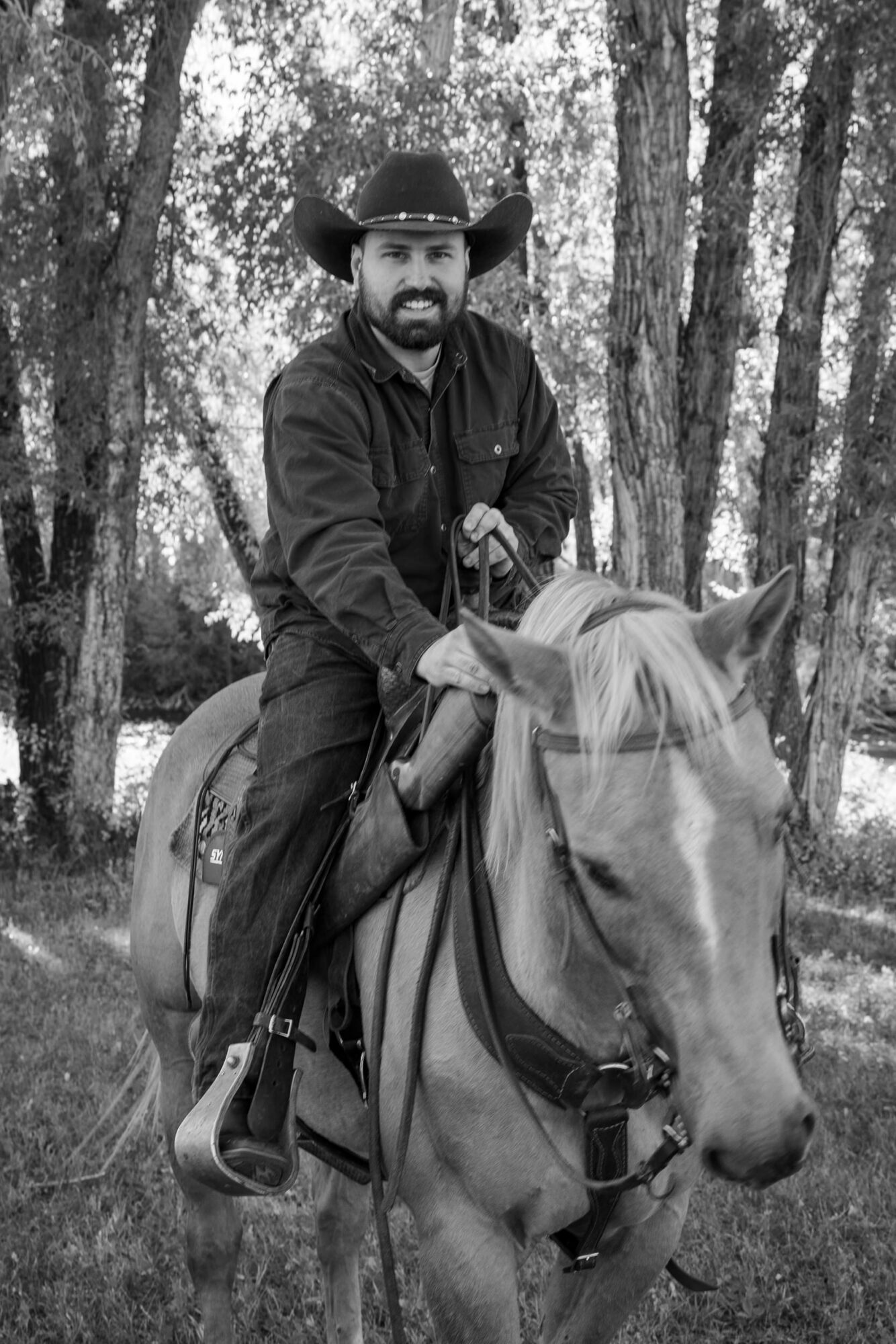A Loveland Pass Elopement in Colorado: Horseback Riding and a Mountain Wedding | Scenic Vows Groom riding a horse during a western-style elopement experience in Colorado