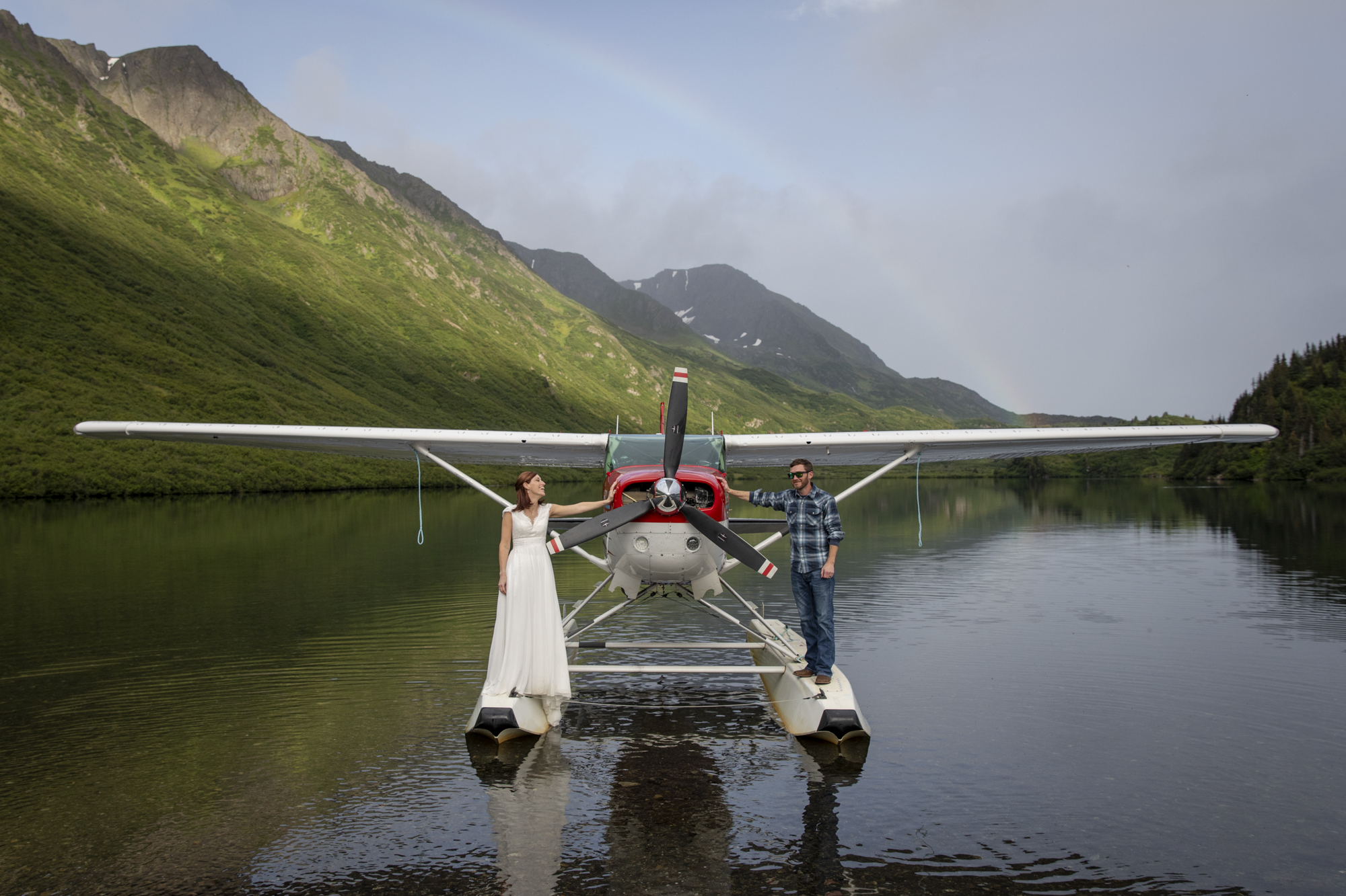 Where to Elope: How to Choose the Perfect Elopement Location | Scenic Vows couple standing on floatplane at remote alpine lake during Alaska adventure elopement