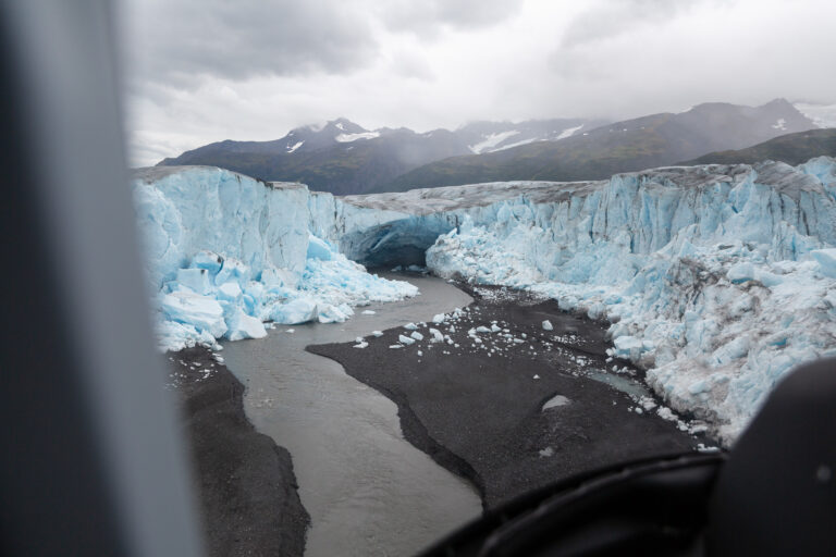 The view from inside of the helicopter looking down at the glacier fields.