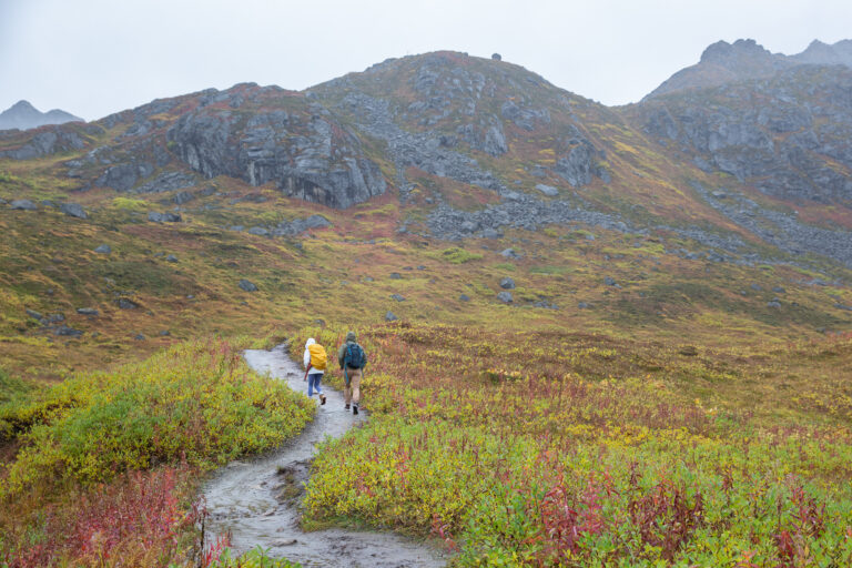 Hiking along a trail that snakes up into the mountains at Hatcher Pass, Alaska.
