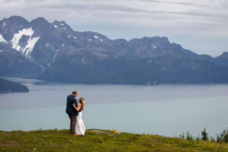A bride and groom share their first dance high above Resurrection Bay on their Alaska elopement day.