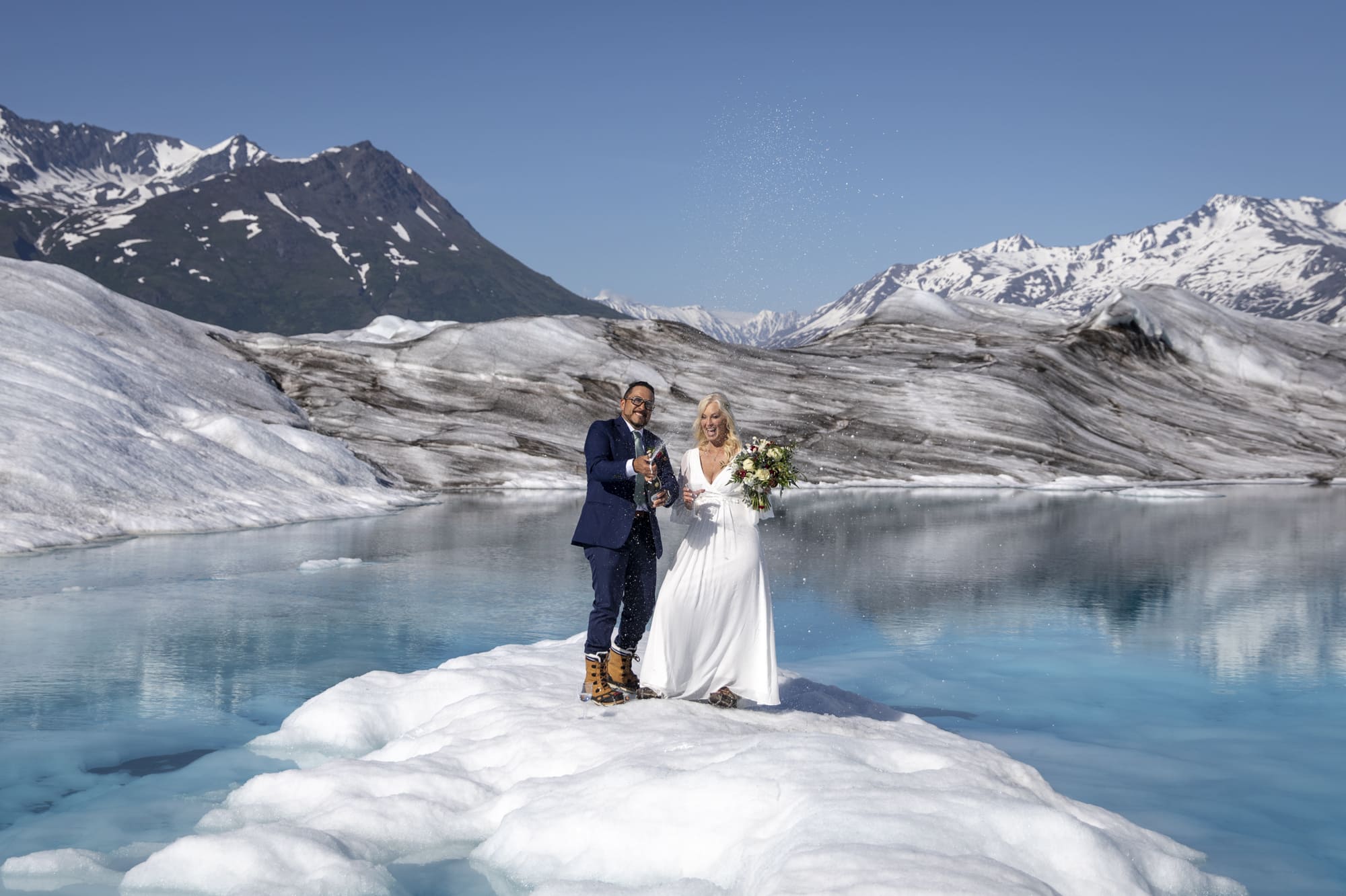 Where to Elope: How to Choose the Perfect Elopement Location | Scenic Vows couple standing on glacier ice beside alpine lake during remote glacier elopement