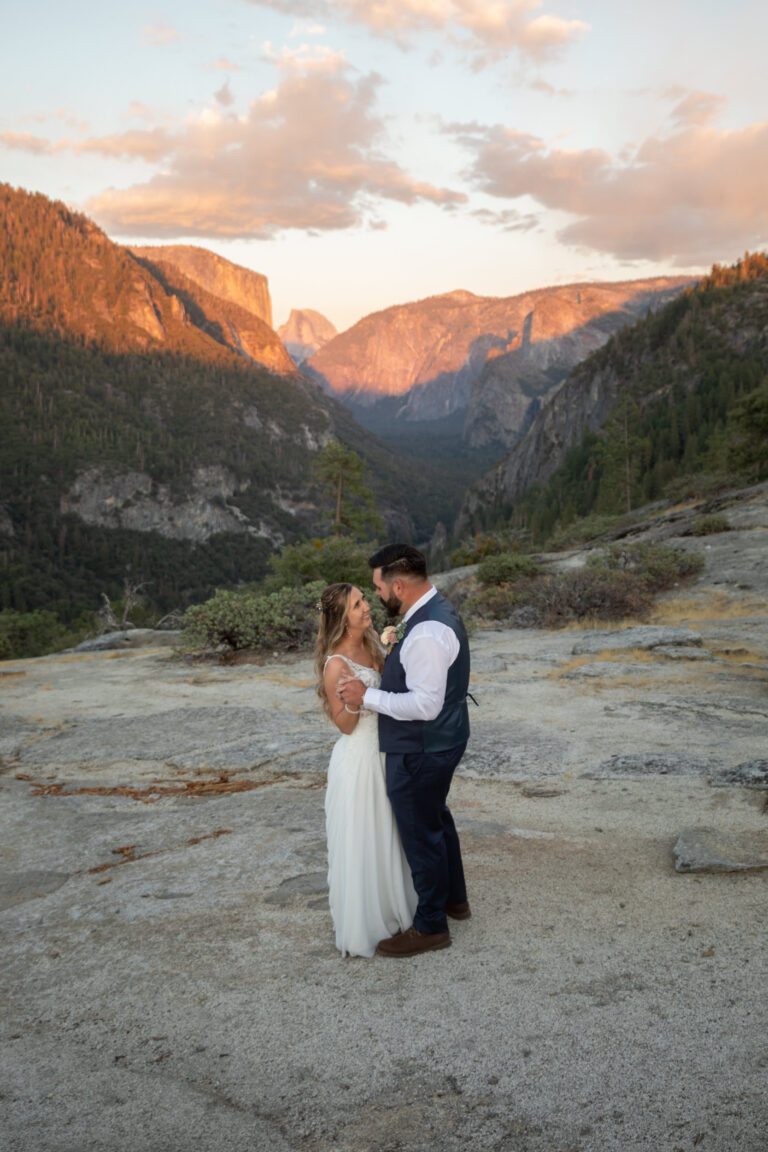 A bride and groom share their first dance on their elopement day as the sunsets behind them in Yosemite National Park