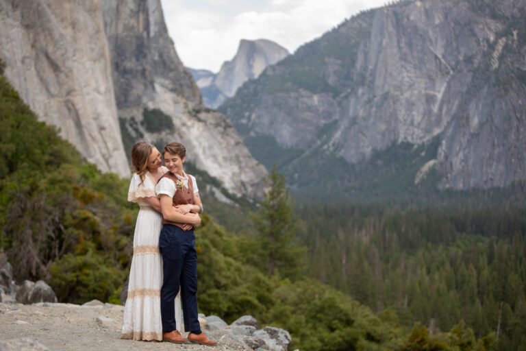A couple stand embracing on their wedding day in Yosemite