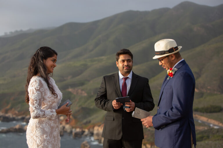 A groom reads his wedding vows to his bride during their cliffside wedding ceremony in Big Sur.