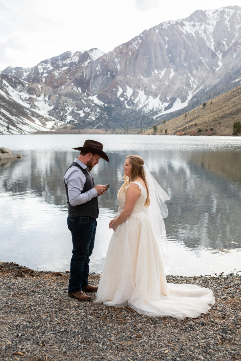 A groom reads his vows to his bride on their Convict Lake wedding day.