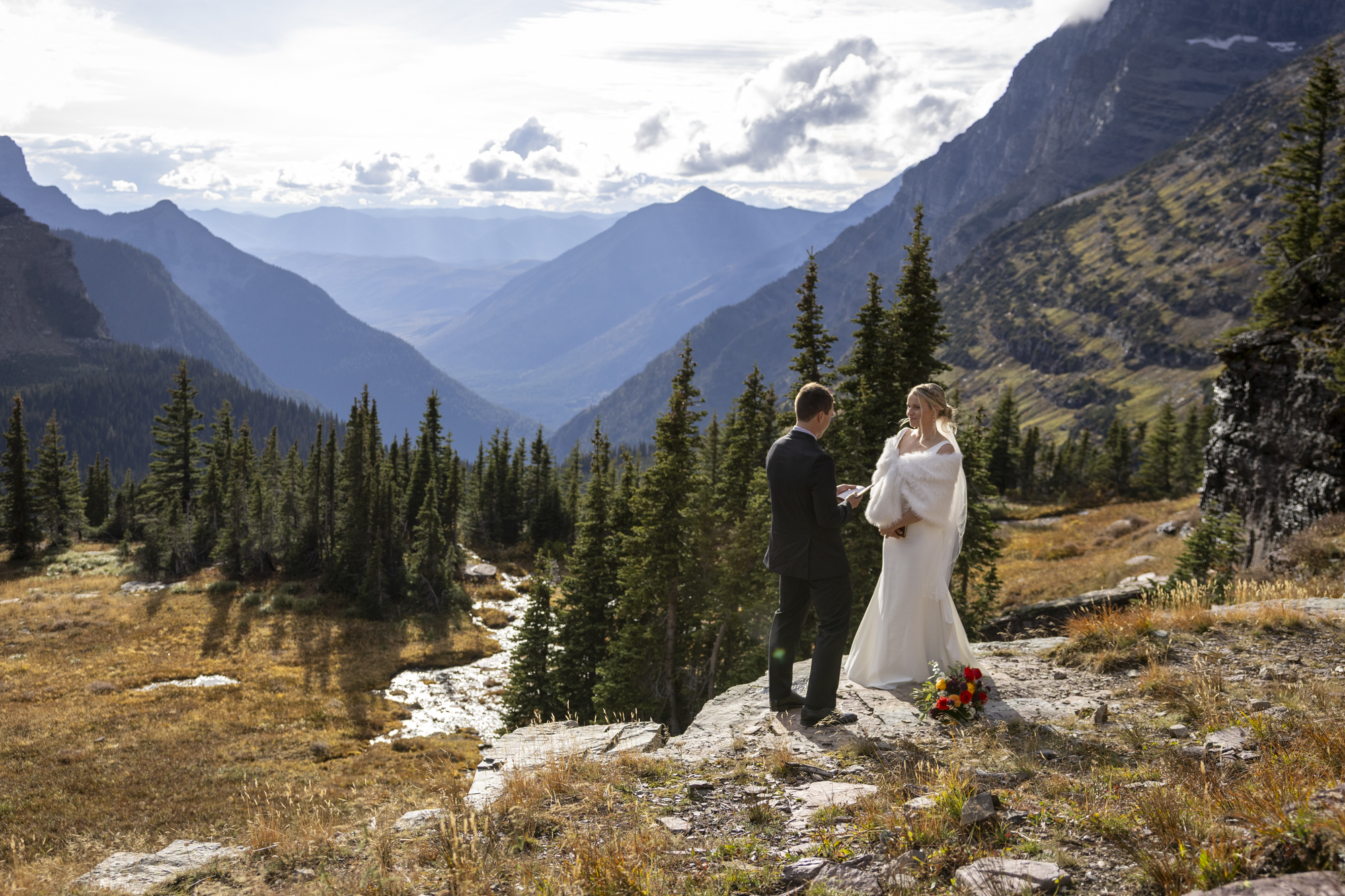 Eloping in Glacier National Park: Your Complete Guide | Scenic Vows A groom reads his vows to his bride in private after they eloped in Glacier National Park