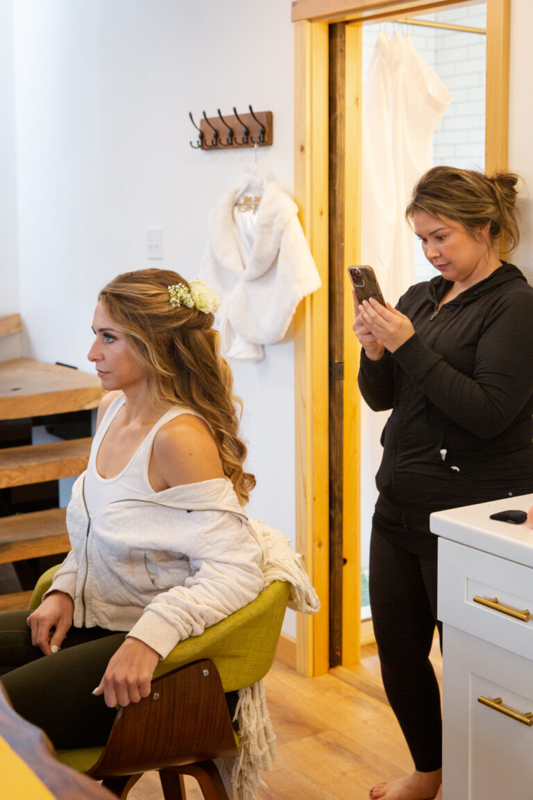 Bride gets her hair and makeup done before her helicopter elopement in Seward Alaska