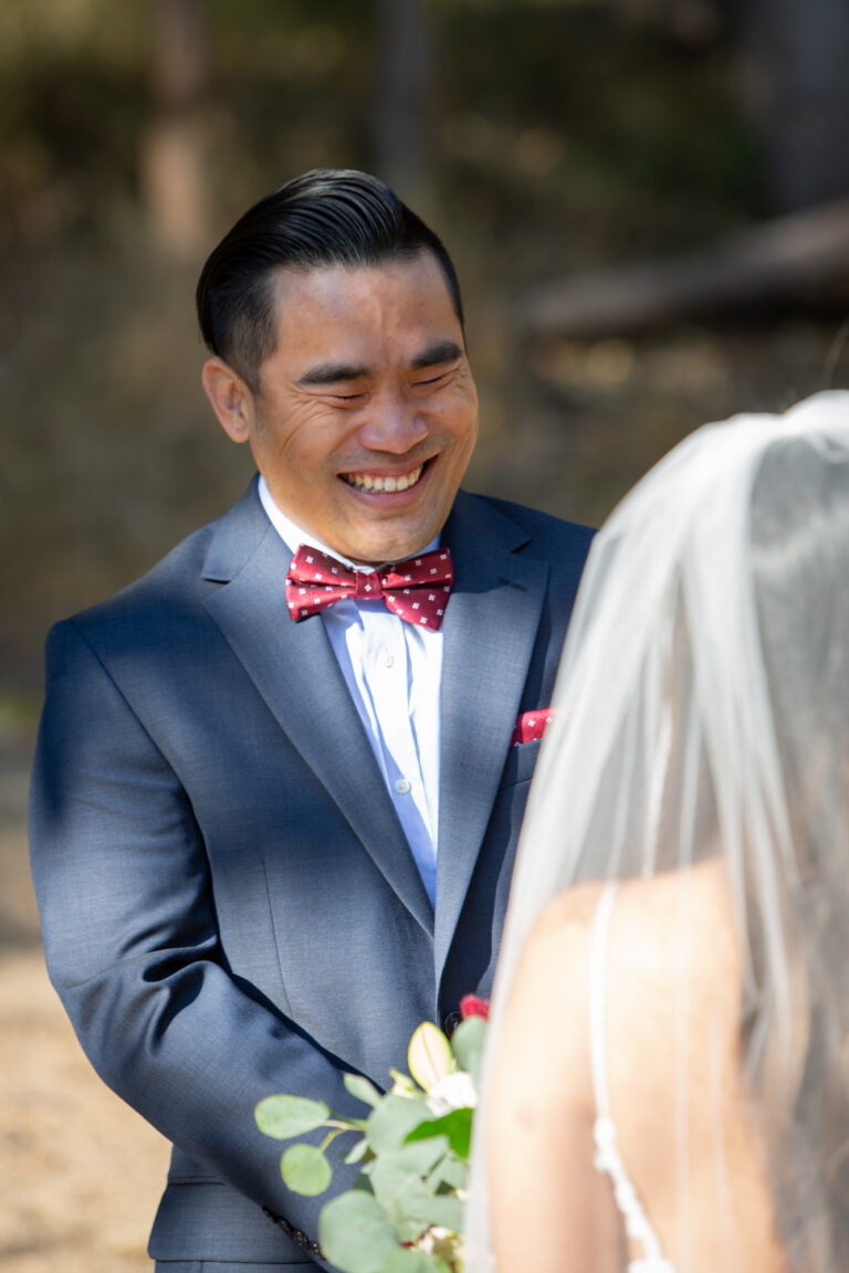 A groom laughs during his intimate wedding ceremony in Yosemite.