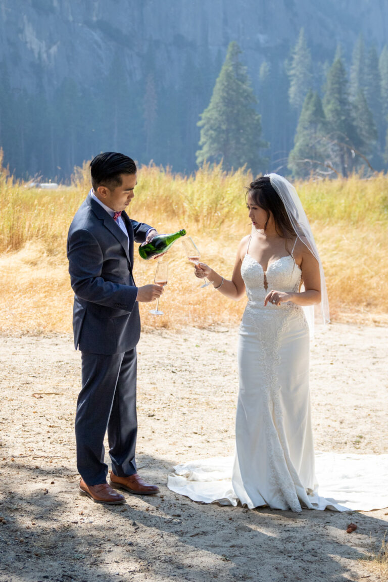 A groom pours champagne for his bride on their intimate elopement day in Yosemite.