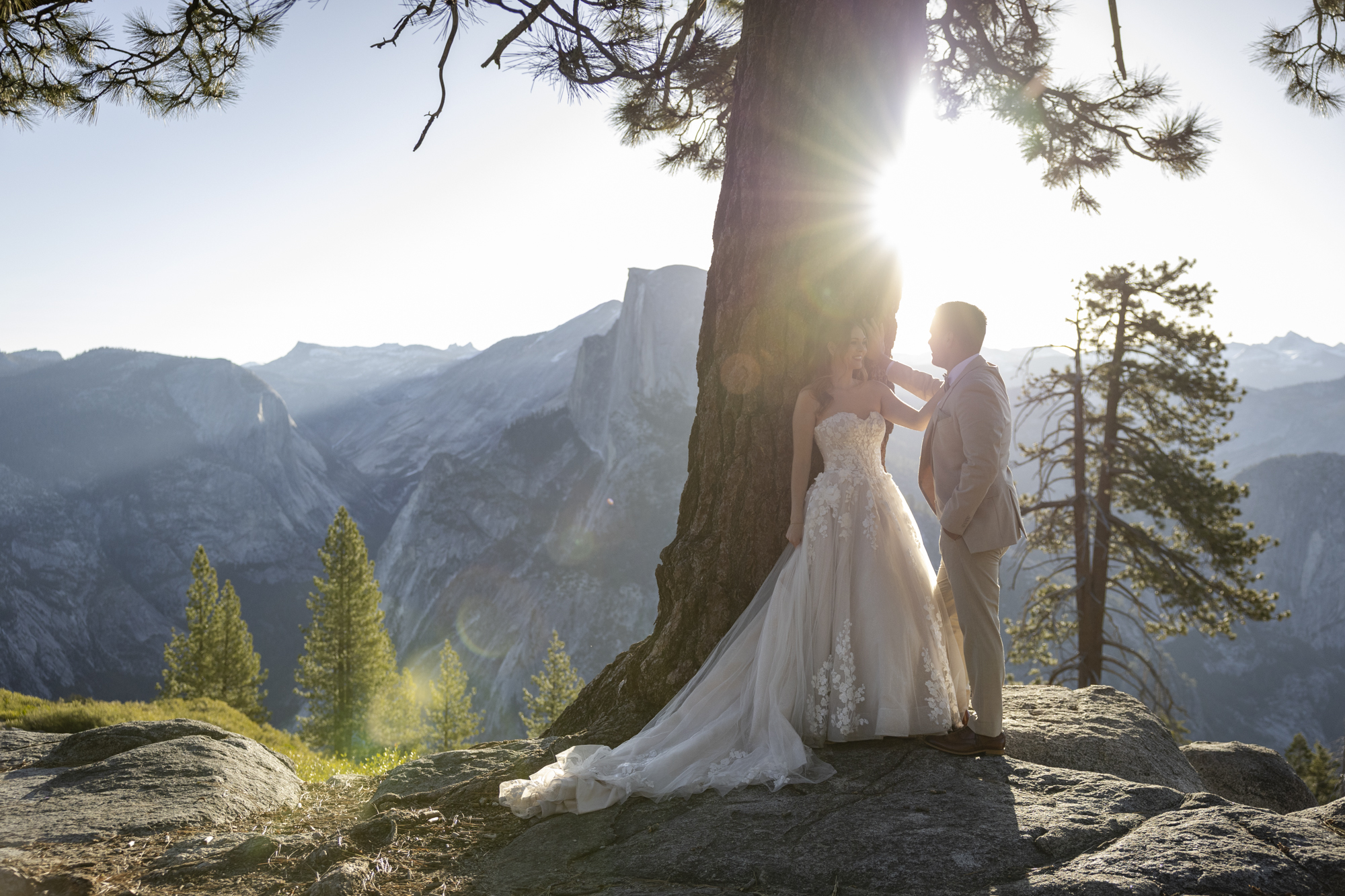 Where to Elope: How to Choose the Perfect Elopement Location | Scenic Vows couple standing beside pine tree at scenic mountain overlook during intimate mountain elopement