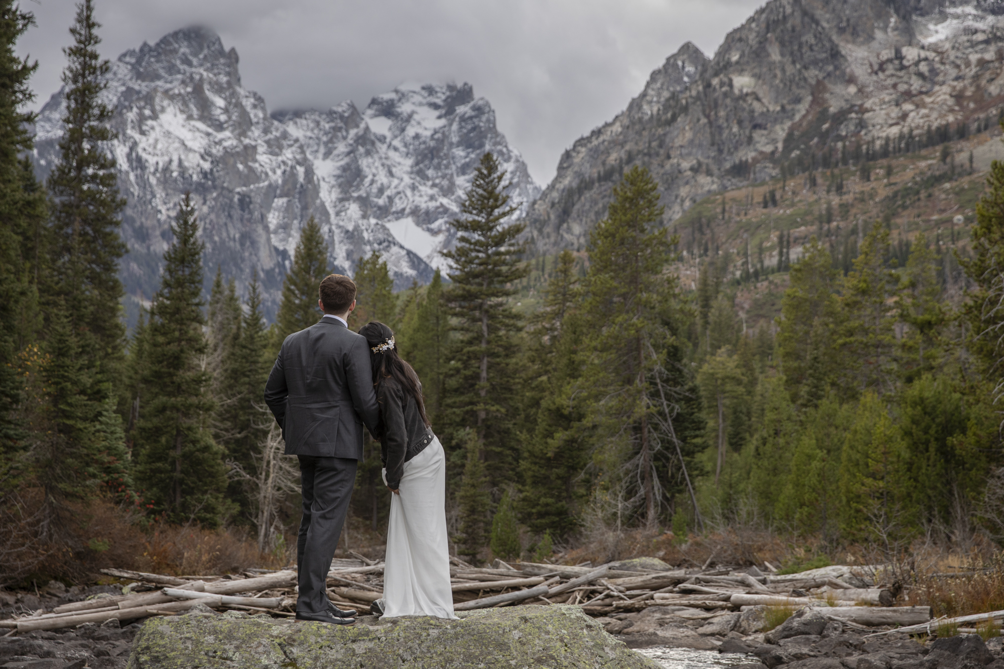 8 Incredible Places to Elope in Wyoming | Scenic Vows Couple exploring a mountain lake at one of the best places to elope in Wyoming