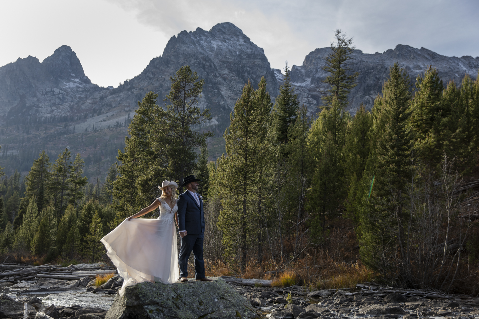 8 Incredible Places to Elope in Wyoming | Scenic Vows Bride and groom surrounded by mountain scenery at one of the best places to get married in Wyoming