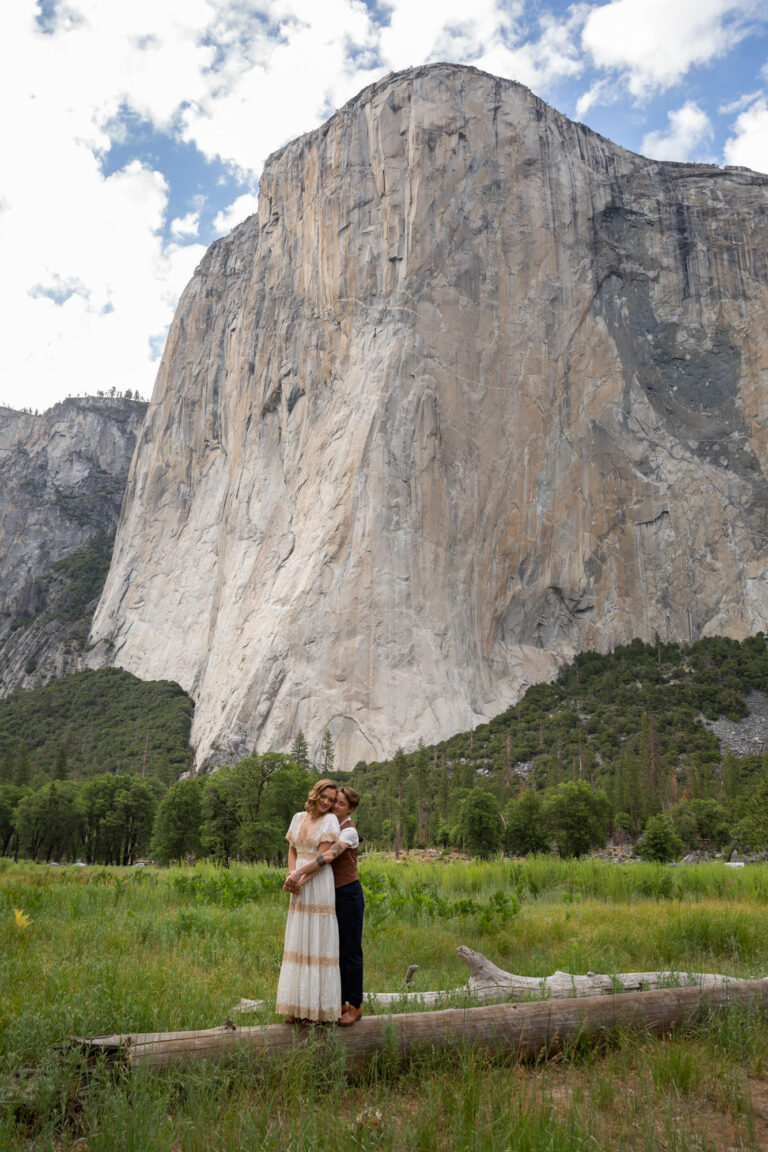 Two brides stand together in El Capitan meadow on their Yosemite elopement day.